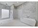 Bathroom with modern soaker tub, frameless glass shower and neutral wall tile at 5880 Westwind Rd, Las Vegas, NV 89118