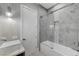 Bathroom featuring modern fixtures, a shower-tub combination with glass doors, and stylish lighting at 5880 Westwind Rd, Las Vegas, NV 89118