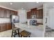 Modern kitchen with stainless steel appliances, granite countertops, a large island with bar stools, and ample cabinet space at 6307 Point Isabel Way, Las Vegas, NV 89122