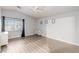 Bright bedroom with wood-look floors, neutral paint, and ample natural light at 6525 Raven Hall St, North Las Vegas, NV 89084