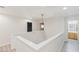 Bright hallway featuring modern lighting, neutral walls, and access to multiple rooms at 6525 Raven Hall St, North Las Vegas, NV 89084