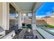 Covered back patio featuring a grill, patio seating, and views of the pool at 690 Monroe Hill Pl, Henderson, NV 89011