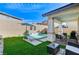 Backyard with a small pool, turf and a sitting area with grill at 690 Monroe Hill Pl, Henderson, NV 89011