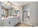 Elegant primary bathroom with a double vanity, modern lighting, and neutral tones, providing a serene and functional space at 690 Monroe Hill Pl, Henderson, NV 89011