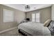 Cozy bedroom featuring neutral walls, a fan light, and carpet flooring at 690 Monroe Hill Pl, Henderson, NV 89011