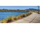 Scenic view of a community pond with benches and walking paths at 690 Monroe Hill Pl, Henderson, NV 89011