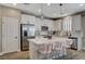 Well-equipped kitchen featuring stainless steel appliances, a large island, and modern fixtures at 690 Monroe Hill Pl, Henderson, NV 89011
