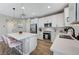 Modern kitchen features stainless steel appliances, an island with seating, and sleek white cabinetry at 690 Monroe Hill Pl, Henderson, NV 89011