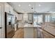 Bright kitchen with stainless steel appliances, a large island, and views of the living area at 690 Monroe Hill Pl, Henderson, NV 89011