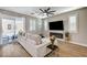 Stylish living room with access to the backyard, a fireplace, and a mounted TV at 690 Monroe Hill Pl, Henderson, NV 89011