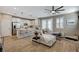 Open-concept living room and kitchen area with modern finishes and lots of natural light at 690 Monroe Hill Pl, Henderson, NV 89011