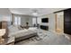 Spacious main bedroom with neutral colors, natural light, and en-suite bathroom with barn door at 690 Monroe Hill Pl, Henderson, NV 89011