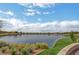 Picturesque pond with fountain features, lush landscaping, and clear blue skies at 690 Monroe Hill Pl, Henderson, NV 89011