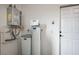 This utility room features a water heater, water softener, and a white door at 690 Monroe Hill Pl, Henderson, NV 89011