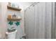 Bathroom featuring decorative floating shelves and a tiled shower with shower curtain at 7143 Nodding Thistle Ct, Las Vegas, NV 89178