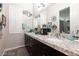 Bathroom features double sinks, granite countertops, and vanity mirrors at 7143 Nodding Thistle Ct, Las Vegas, NV 89178