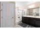 Bathroom featuring double sinks, tile floors, a shower with glass door, and dark cabinets at 7253 Sterling Rock Ave, Las Vegas, NV 89178