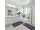Well-lit bathroom with double sinks, a soaking tub, and a glass-enclosed shower at 7722 Sagamore Bay Ct, Las Vegas, NV 89179