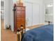 Bright bedroom featuring a wood dresser, sliding closet doors, and an ensuite bathroom at 7722 Sagamore Bay Ct, Las Vegas, NV 89179