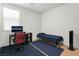 Spare bedroom shows a computer, desk, chair, single bed and tower fan at 7722 Sagamore Bay Ct, Las Vegas, NV 89179