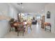 Open-concept dining area with a round table, chandelier, and lots of natural light at 7722 Sagamore Bay Ct, Las Vegas, NV 89179