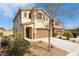 Two-story home featuring desert landscaping, a tile roof, and a two-car garage at 7722 Sagamore Bay Ct, Las Vegas, NV 89179