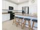 Bright kitchen featuring a central island with counter seating and sleek, modern appliances at 7722 Sagamore Bay Ct, Las Vegas, NV 89179