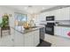 Bright kitchen with an island, granite countertops, modern appliances, and lots of natural light at 7722 Sagamore Bay Ct, Las Vegas, NV 89179