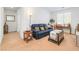 Bright and cozy living room featuring a comfortable blue couch and stylish decor at 7722 Sagamore Bay Ct, Las Vegas, NV 89179