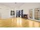 Bright living room boasting hardwood floors, a brick fireplace, and sliding glass doors at 8125 Cactus Flower Ct, Las Vegas, NV 89145