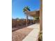 Relaxing back patio with latticed overhang and low-maintenance desert landscaping at 8125 Rio De Janeiro Dr, Las Vegas, NV 89128