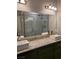 Bathroom featuring a double vanity with granite counters and tiled shower at 8125 Rio De Janeiro Dr, Las Vegas, NV 89128