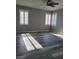 Bedroom with gray walls, wood-look floors, ceiling fan and white shutters at 8125 Rio De Janeiro Dr, Las Vegas, NV 89128