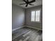 Bedroom with gray walls, wood-look floors and a window with white shutters at 8125 Rio De Janeiro Dr, Las Vegas, NV 89128