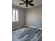 Bedroom with wood-look floors, white shutters, and a ceiling fan at 8125 Rio De Janeiro Dr, Las Vegas, NV 89128