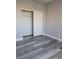 Bedroom with wood-look floors and a sliding door closet at 8125 Rio De Janeiro Dr, Las Vegas, NV 89128