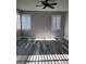 Bedroom with gray walls, wood-look floors, ceiling fan and white shutters at 8125 Rio De Janeiro Dr, Las Vegas, NV 89128