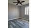 Bedroom with wood-look floors, white shutters, and a ceiling fan at 8125 Rio De Janeiro Dr, Las Vegas, NV 89128
