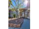 Inviting front yard with desert landscaping, mature tree, and classic architecture at 8125 Rio De Janeiro Dr, Las Vegas, NV 89128