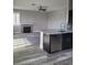 Modern kitchen with stainless steel appliances and granite countertops overlooks the adjacent living area at 8125 Rio De Janeiro Dr, Las Vegas, NV 89128