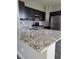 Kitchen island with granite countertops and stainless steel appliances at 8125 Rio De Janeiro Dr, Las Vegas, NV 89128