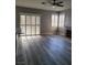 Living room featuring wood floors, fireplace, and sliding glass door with plantation shutters at 8125 Rio De Janeiro Dr, Las Vegas, NV 89128
