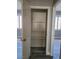 Walk-in pantry featuring wooden shelves for optimal storage and wood-look floors at 8125 Rio De Janeiro Dr, Las Vegas, NV 89128