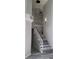 Modern staircase with white railing, soaring ceilings, and contemporary light fixture at 8125 Rio De Janeiro Dr, Las Vegas, NV 89128
