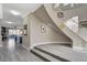 Elegant foyer featuring a curved staircase and neutral decor leading to other rooms at 8740 Carlitas Joy Ct, Las Vegas, NV 89117