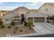 Charming two-story home with a well-manicured front yard and a spacious three-car garage at 8985 Tierra Santa Ave, Las Vegas, NV 89129