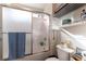 Bright bathroom featuring a white shower/tub combo with a sliding glass door at 9293 Boltonia Ct, Las Vegas, NV 89149