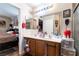 This bathroom features a double sink vanity and is open to the bedroom at 9293 Boltonia Ct, Las Vegas, NV 89149