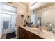 Bright bathroom with a shower/tub combo and wood-look vanity at 9293 Boltonia Ct, Las Vegas, NV 89149