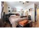 Comfortable bedroom featuring dark wood accents, a ceiling fan, and access to a bathroom at 9293 Boltonia Ct, Las Vegas, NV 89149